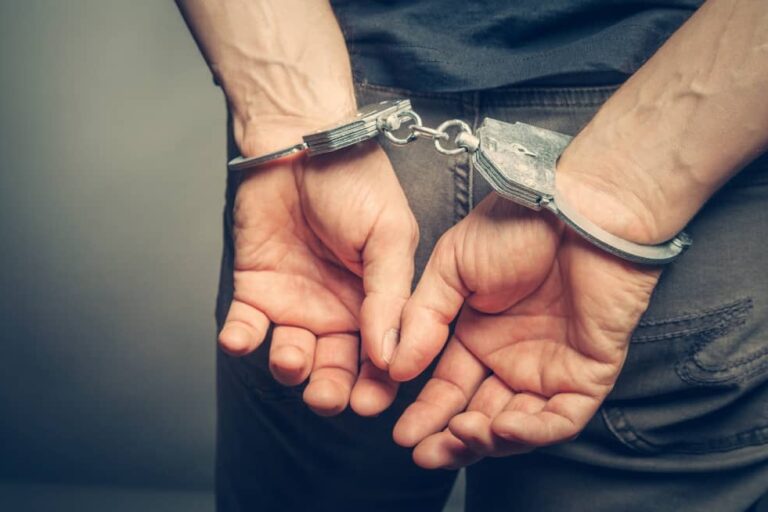 Male hands in handcuffs.
