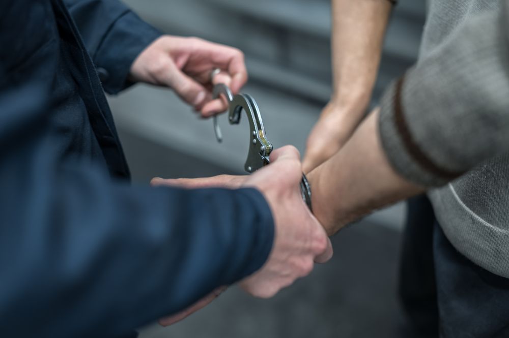 Handcuffs on the prisoner. Making an arrest. Remand in custody