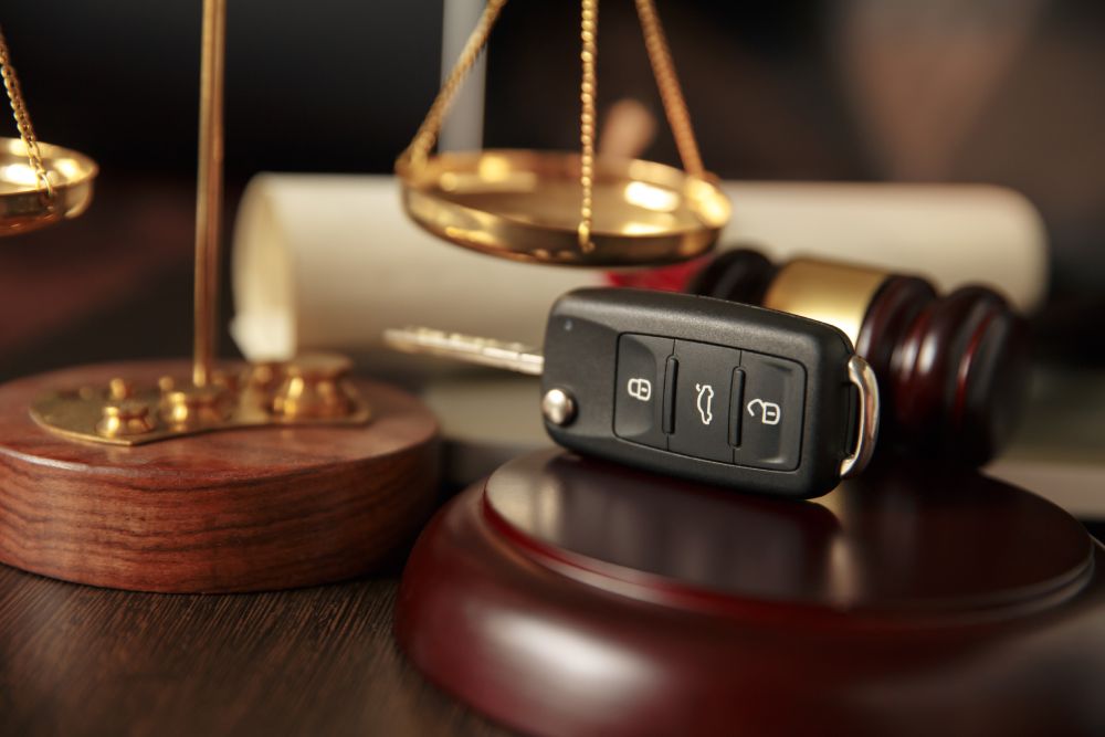 Wooden referee hammer and car keys on the table-top view